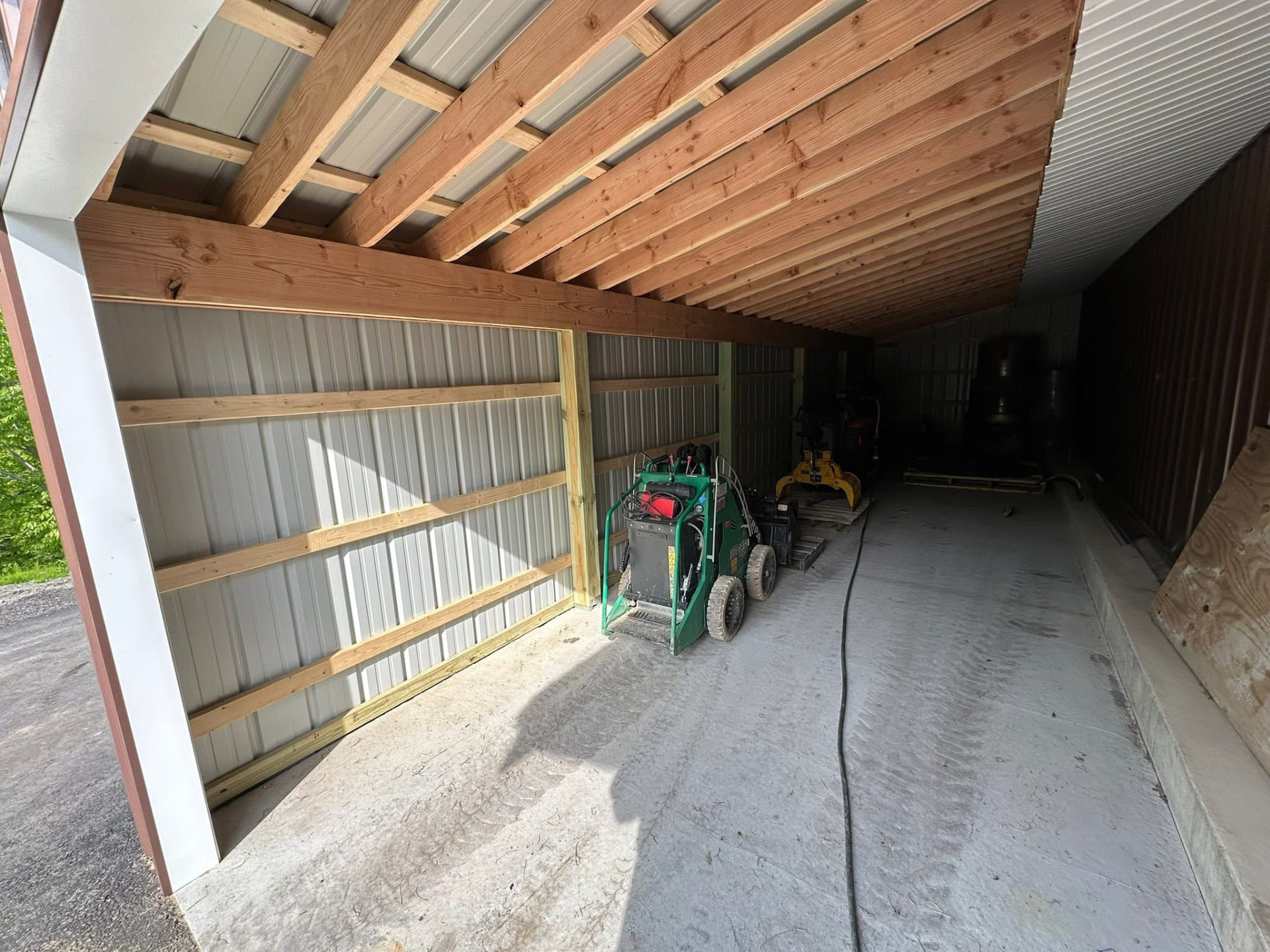 Post-frame barn interior with exposed framing and metal roofing
